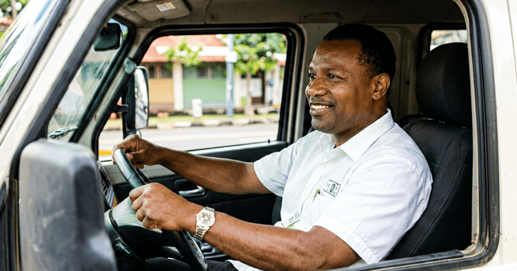 African professional driver behind the wheel of a truck in Maputo
