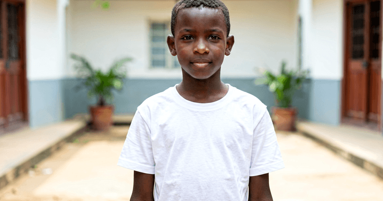 16-year-old Mozambican teenager in a schoolyard in plain uniform preparing for their first job