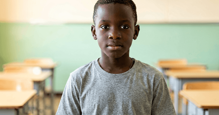 Mozambican teenager in a schoolyard storing work documents