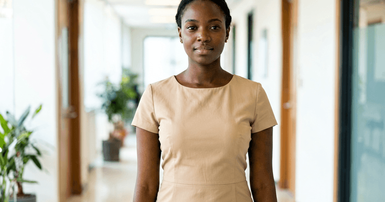 Young Mozambican woman in a school courtyard storing her bank statement