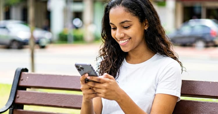 Young person receiving good job news on mobile phone