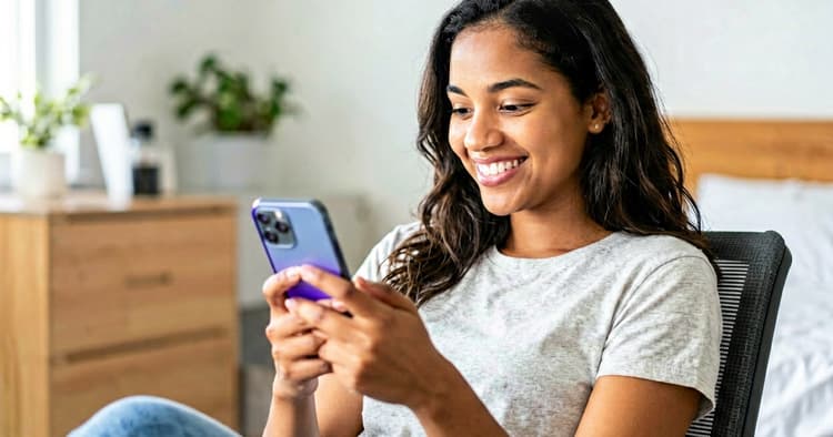 Young person receiving positive application response on phone