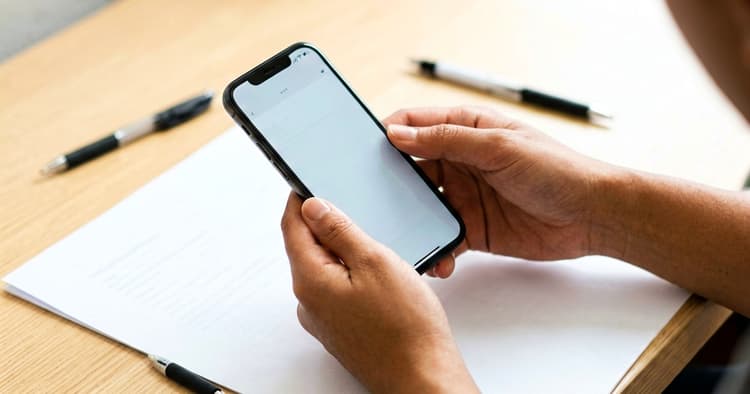 Hands preparing to send a PDF CV on a mobile phone