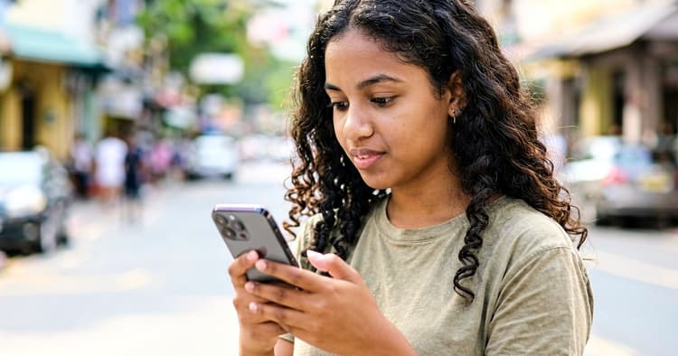 Young person receiving a new job alert notification on a mobile phone