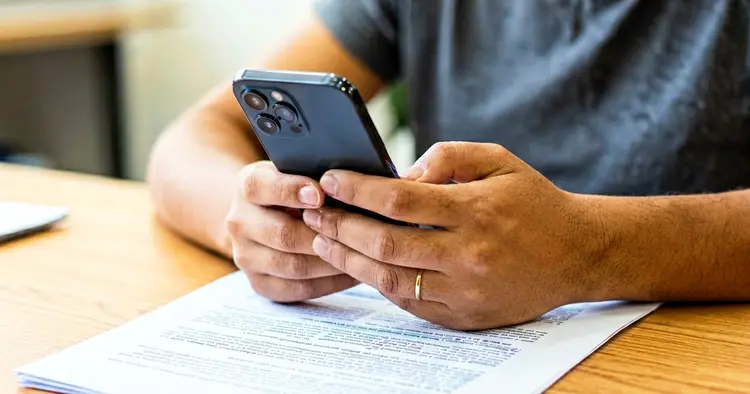 Hands reviewing an application on a mobile phone