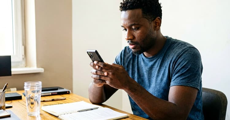 Mozambican female professional reviewing a written salary offer on her laptop before responding