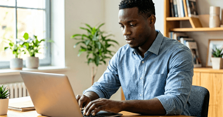 Mozambican professional working remotely in home office with laptop