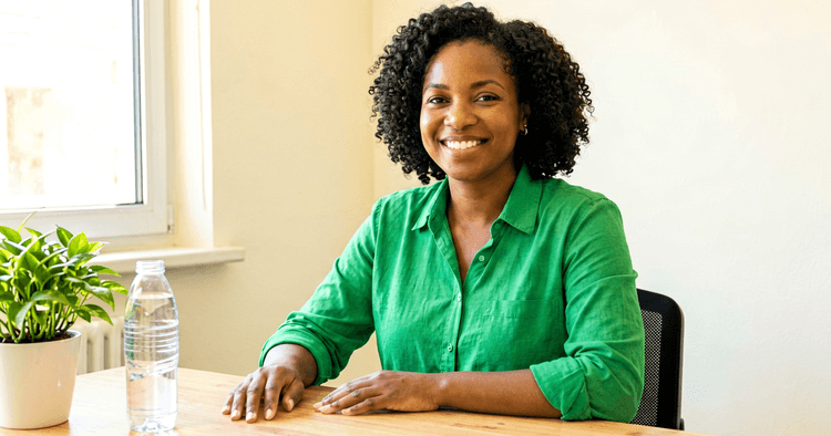 Young Mozambican woman preparing her first job application at home, focused at her desk