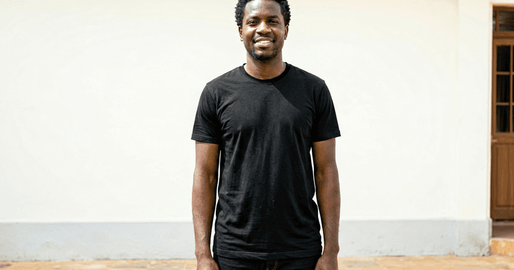 Mozambican first-job student in an outdoor courtyard, calm and confident posture
