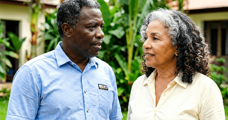 elderly Mozambican couple talking in a residential courtyard in Maputo