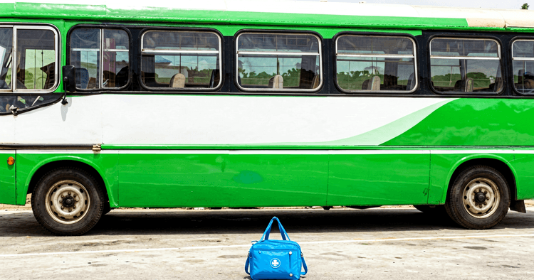 bus station with work briefcase next to a bus, no readable text