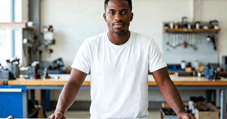Young Mozambican in a workshop yard learning electromechanics