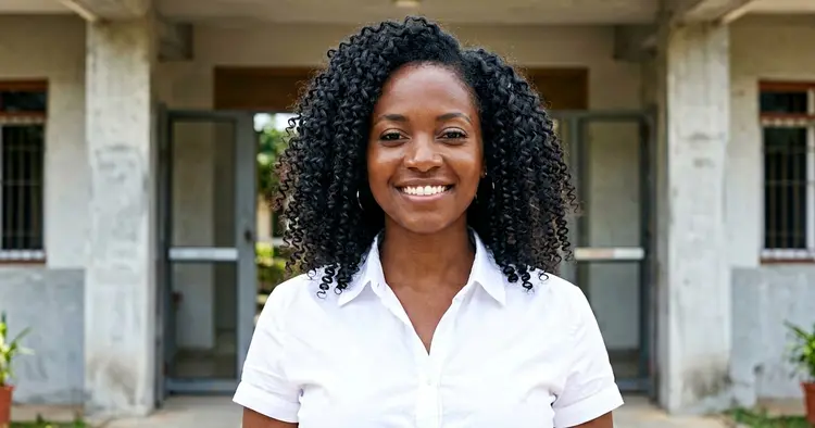 Young Mozambican woman in front of a university thinking about her next step after Grade 12