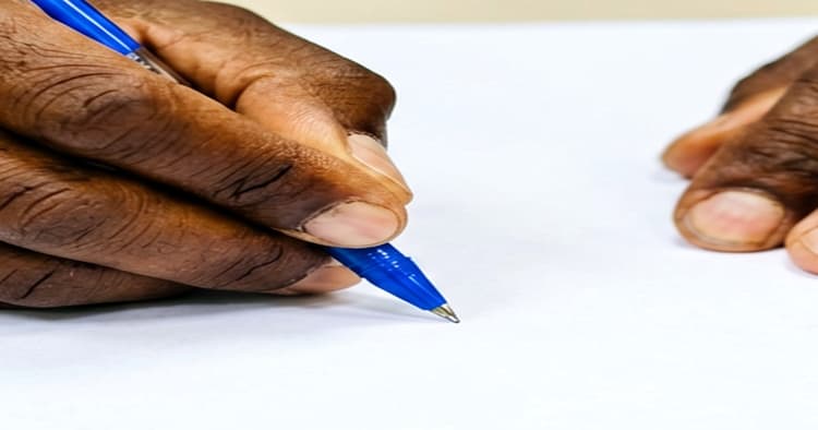 Mozambican app driver reviewing a platform onboarding document on a laptop